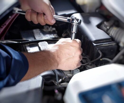 Mechanic working in auto repair garage. Car maintenance